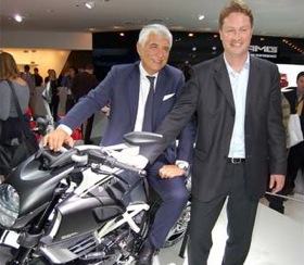 Ducati CEO Gabriele Del Torchio straddles the Ducati Diavel AMG Special Edition, next to AMG president Ola Kallenius. (Photo by Mark Vaughn.)