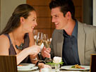 Image: Couple toasting champagne glasses at restaurant table (© Chris Ryan/OJO Images/Getty Images)