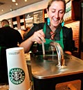 Credit: (© Anthony Bolante/Reuters)
Caption: Starbucks barista