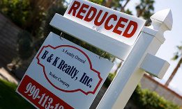 Real Estate Sign Advertising Reduced Price (©moodboard/Alamy, Pharaoh/Alamy)