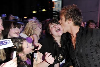 Charlie Bewley bites a happy fan.